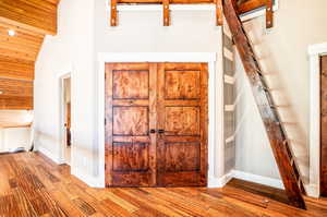 Entrance foyer featuring vaulted ceiling and light wood-type flooring