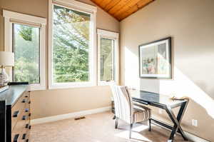 Carpeted home office featuring lofted ceiling and wooden ceiling