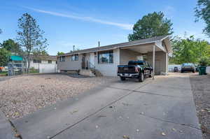 Single story home featuring a carport