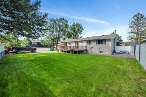 View of yard featuring central AC unit and a deck