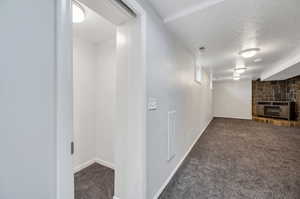 Interior space with carpet floors and a textured ceiling