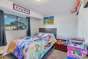 Bedroom featuring light carpet