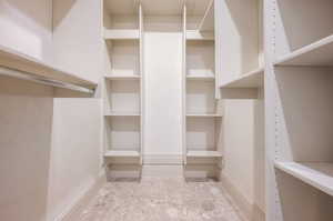 Spacious closet with light tile patterned floors