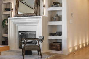 Interior space with built in shelves and wood-type flooring