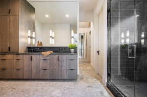 Bathroom with vanity, walk in shower, and tile patterned floors