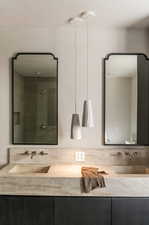 Bathroom featuring an enclosed shower and vanity