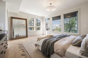 Bedroom featuring light hardwood / wood-style floors and multiple windows