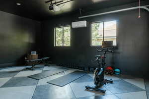 Exercise room featuring an AC wall unit