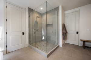 Bathroom with tile patterned floors and an enclosed shower