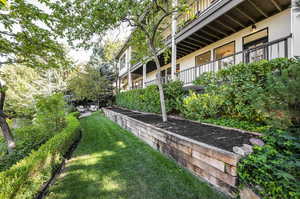 View of yard with a balcony