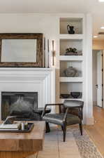 Living area featuring hardwood / wood-style flooring and built in shelves