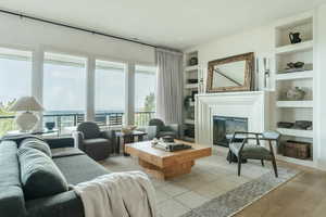 Living room with built in features and light wood-type flooring