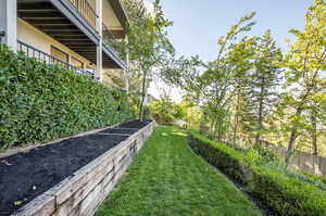 View of yard with a balcony