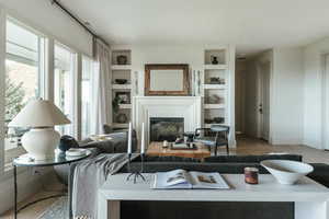 Living room featuring built in features and light wood-type flooring