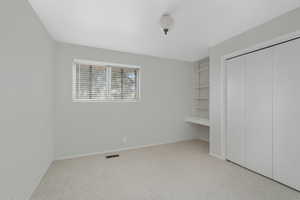 Bedroom 2 Unfurnished bedroom featuring a closet and light colored carpet