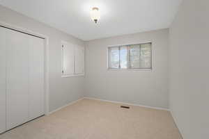 Bedroom 3 Unfurnished bedroom with a closet and light colored carpet