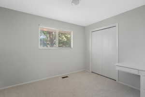 Bedroom 4 Unfurnished bedroom featuring light colored carpet and a closet