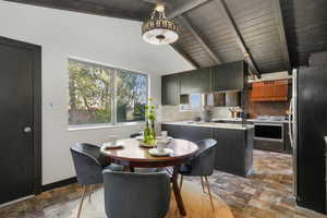 Dining space featuring lofted ceiling with beams and wood ceiling