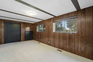 Bedroom 5 with wooden walls and carpet flooring