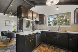 Kitchen featuring sink, stainless steel dishwasher, vaulted ceiling with beams, and wooden ceiling