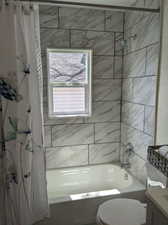 Full bathroom featuring shower / bath combo, toilet, and vanity