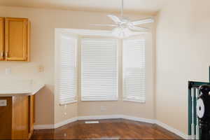 Unfurnished dining area featuring ceiling fan and hardwood / wood-style flooring