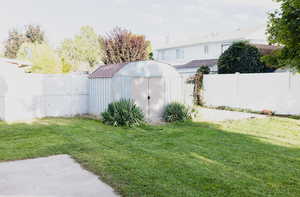 View of yard featuring a storage unit