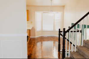 Foyer with hardwood / wood-style flooring and ceiling fan