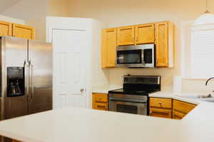 Kitchen featuring sink, stainless steel appliances, and pendant lighting