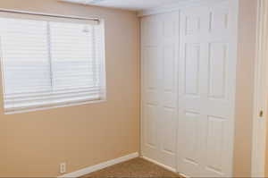 Unfurnished bedroom with a closet and carpet