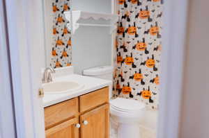 Bathroom featuring tile patterned floors, a shower with shower curtain, vanity, and toilet