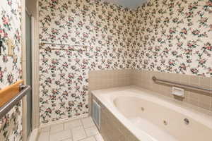 Bathroom featuring separate shower and tub and tile patterned floors