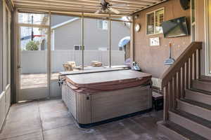 Screened patio with Hot tub, sitting area, and speakers