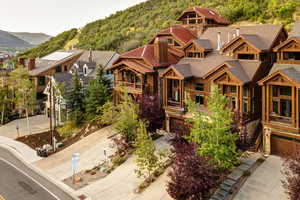 View of front of house with a mountain view and a garage