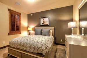 Carpeted bedroom with a textured ceiling