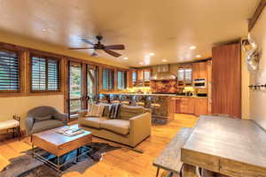 Living room with light wood-type flooring and ceiling fan