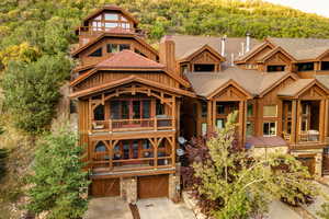 Rear view of property featuring a garage and a balcony