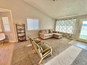 Living room featuring light hardwood / wood-style flooring and vaulted ceiling