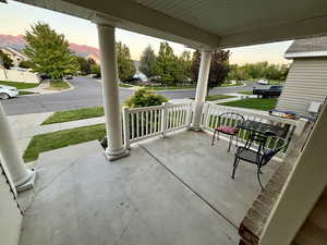 Patio terrace at dusk with covered porch