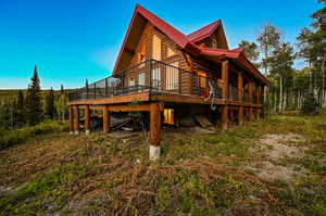 View of property exterior featuring a wooden deck