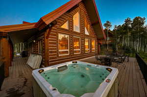 Wooden terrace featuring an outdoor hot tub