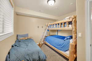 Carpeted bedroom with a textured ceiling