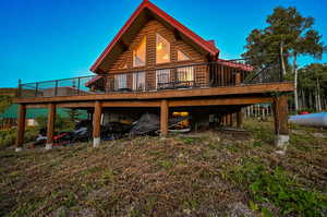 Rear view of house featuring a wooden deck