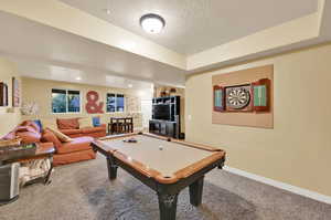 Playroom featuring billiards, carpet flooring, and a textured ceiling