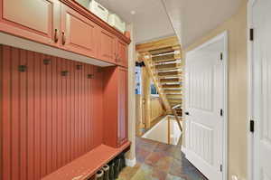 Mudroom with a textured ceiling and dark tile patterned floors