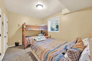 Carpeted bedroom with a textured ceiling