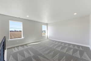 Empty room featuring light carpet and recessed lighting
