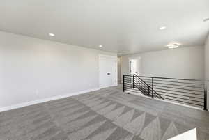 Empty room featuring light carpet and recessed lighting