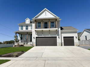 View of front facade featuring a porch, concrete driveway, board and batten siding, and an attached garage