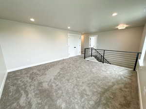 Unfurnished room featuring recessed lighting and carpet flooring